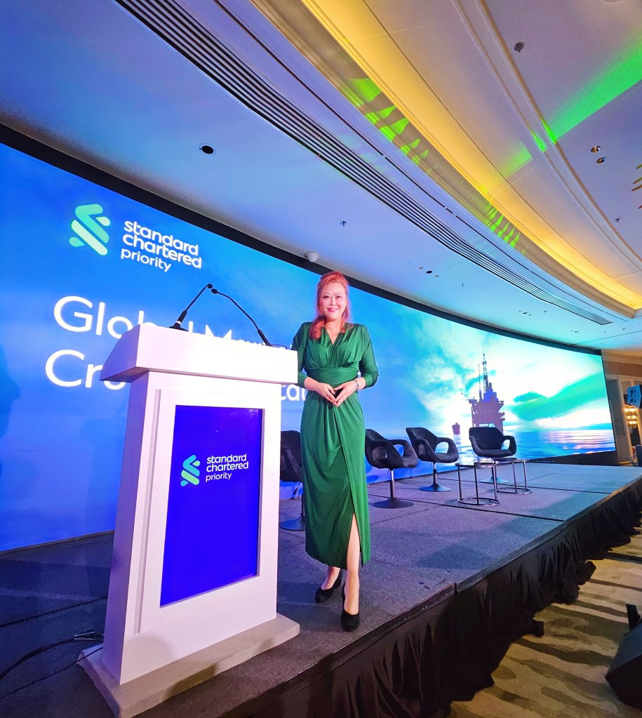Sylvia Tham engaging audience as bilingual emcee at corporate conference Singapore