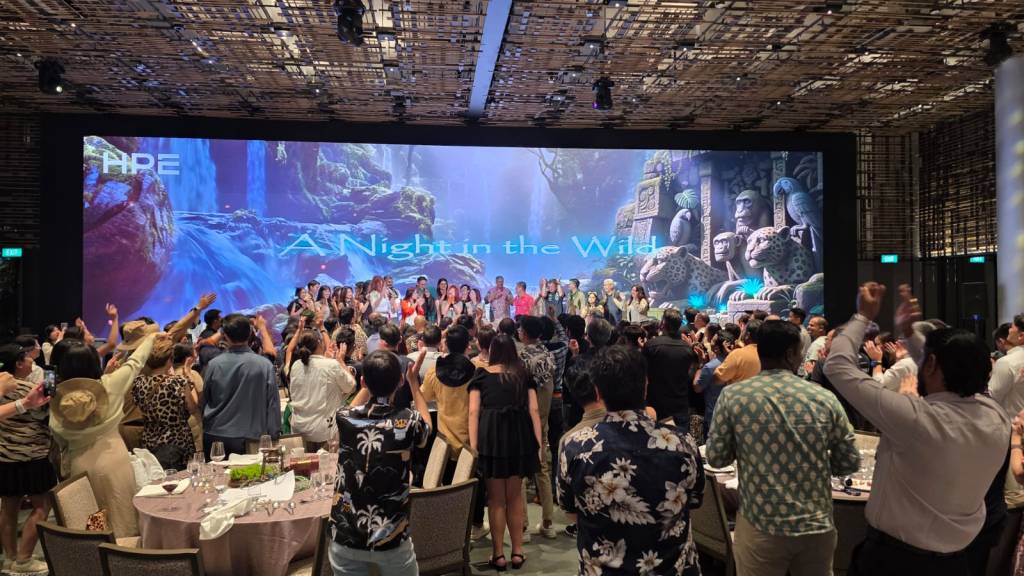 Sylvia Tham professional corporate MC emceeing annual dinner on stage in Singapore